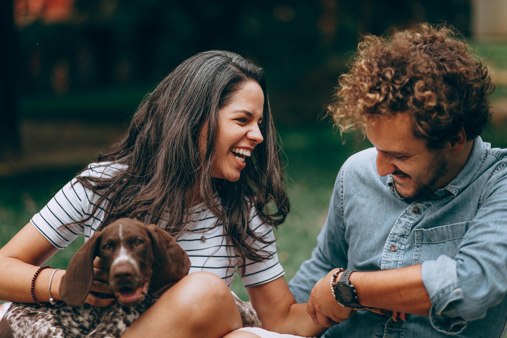 Man and Woman with their Pet Dog in the park